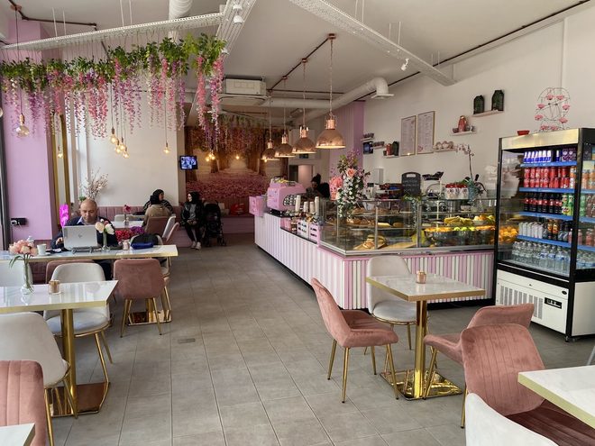 The pink dining room with its hanging blossom ceiling and pastry counter.