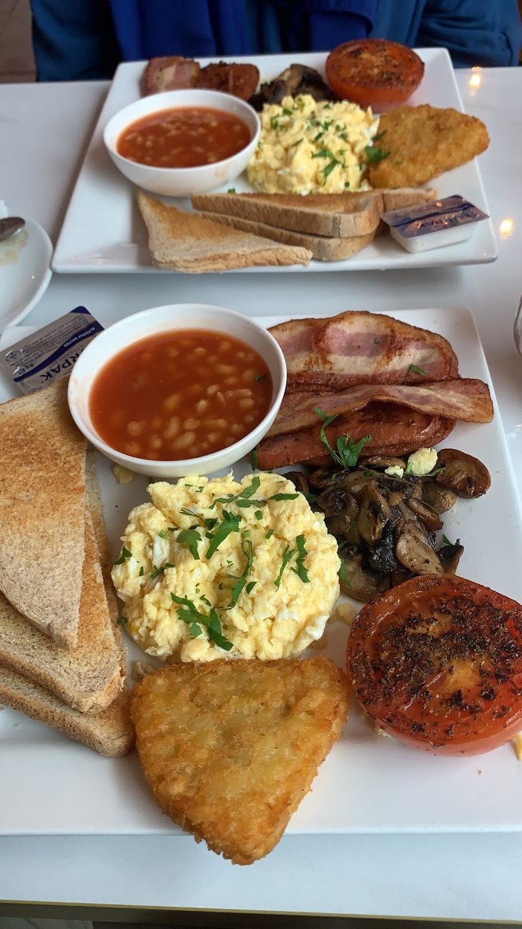 Full English breakfast with beans, scrambled egg, bacon, mushrooms, tomato and hash brown.